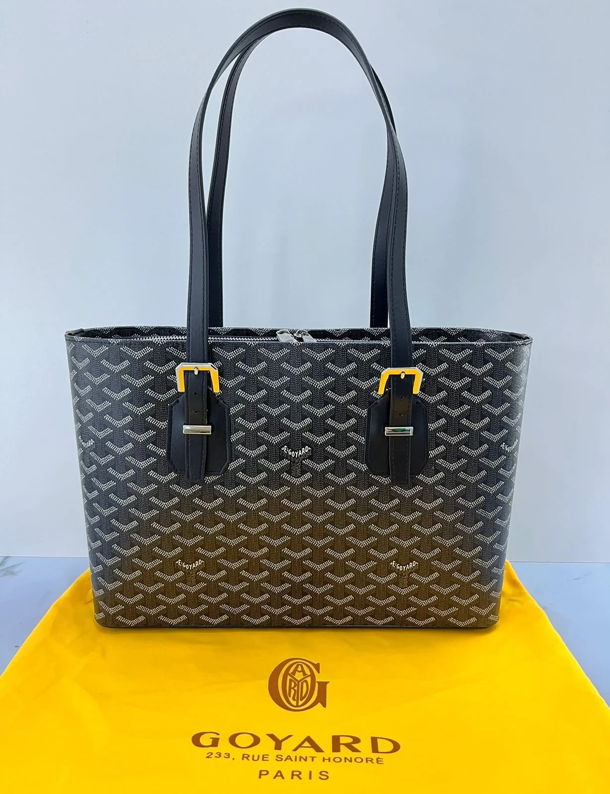 Goyard-Inspired Classic Patterned Tote Bag Full view of a spacious tote bag with a signature green geometric pattern (Goyard style), white stitching, and adjustable buckle details, standing on a branded dust bag.