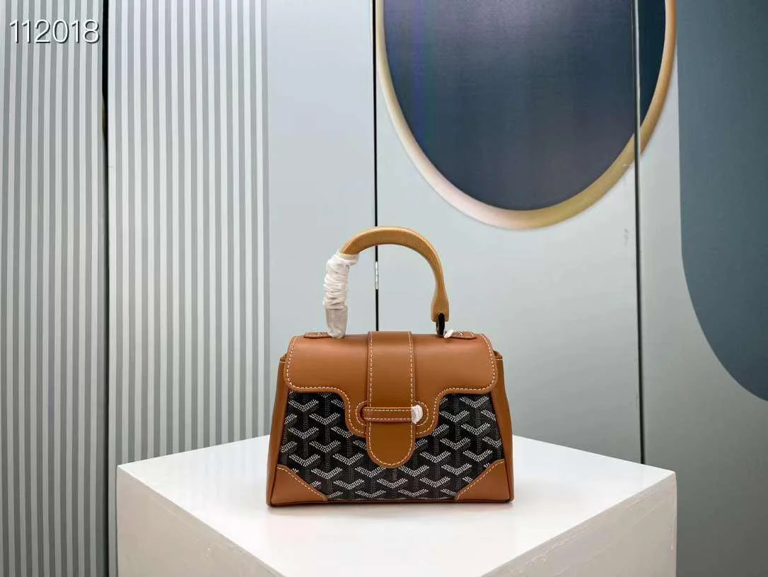 Structured Top Handle Bag with Wood Handle Front view of a rigid, structured handbag (Goyard Saïgon style) featuring a signature chevron/Y-pattern, wooden top handle, and corner reinforcements.