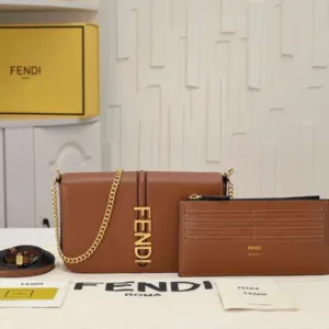 Model wearing the Fendigraphy WOC cross-body to show the length of the $54\text{ cm}$ chain strap drop.