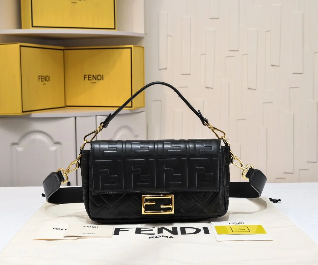 Fendi-Baguette-Black-Leather-3D-FF-Clasp Close-up of the medium black Fendi Baguette bag, highlighting the 3D embossed FF motif and gold-finish FF clasp.