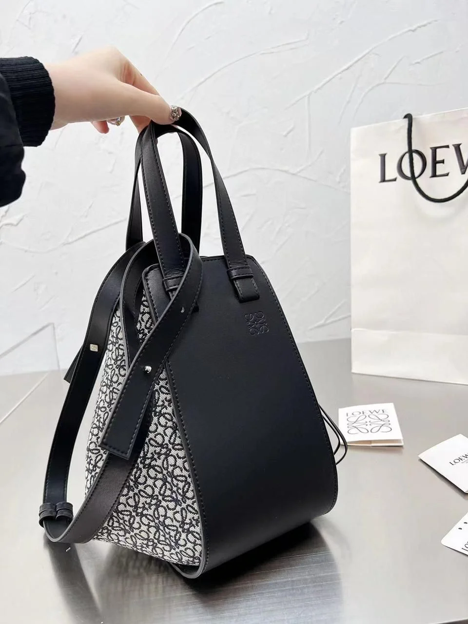 Loewe Small Hammock Black Anagram Canvas Handbag Full view of the Loewe Small Hammock bag in black calfskin and black/grey Anagram jacquard canvas, highlighting the top handles and detachable strap.
