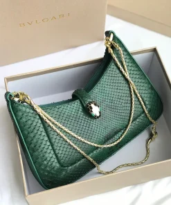 Bvlgari Serpenti Forever top handle bag in emerald green crocodile or python skin.