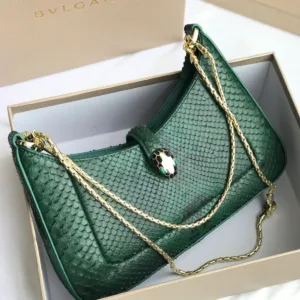Bvlgari Serpenti Forever top handle bag in emerald green crocodile or python skin.