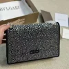 Bvlgari luxury shoulder bag, heavily embellished with crystals or rhinestones on a black background.