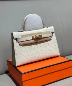 Structured luxury mini ostrich leather handbag placed on display surface