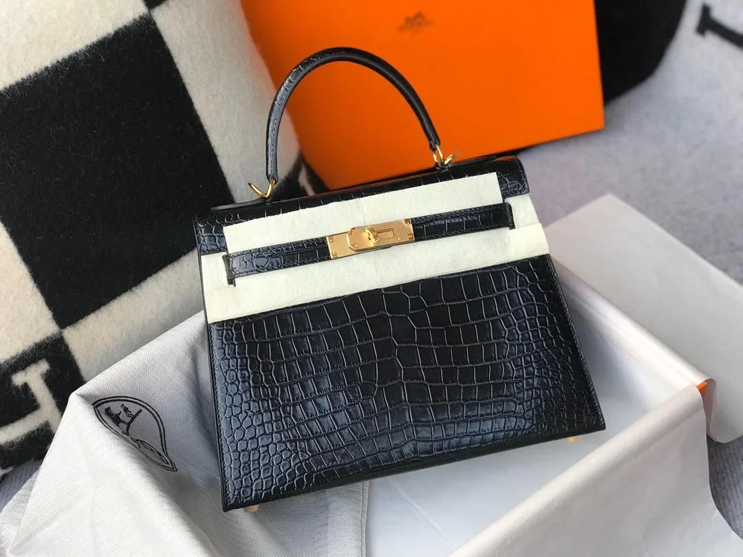 Mini Structured Alligator Bag in Burgundy Full front view of the structured mini top handle bag in deep burgundy shiny alligator leather with silver-tone hardware.