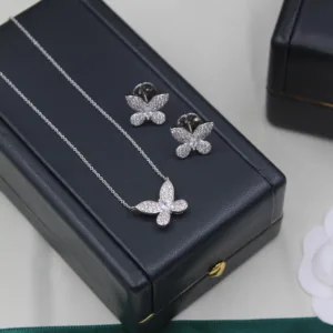 Close-up of silver butterfly necklace and matching earrings with micro-pavé stones