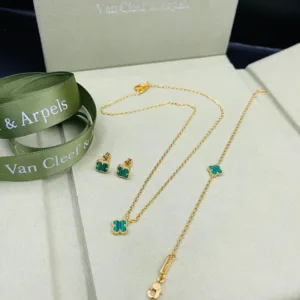 Gold-tone bracelet and necklace featuring clover design alongside earrings