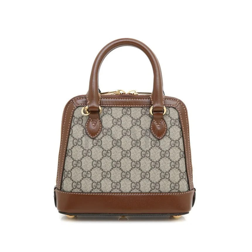 Compact designer-style handbag with adjustable strap Compact top handle handbag in excellent condition on display