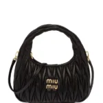 Black Miu Miu Mini Wander bag showing matelassé stitching and gold-tone logo lettering