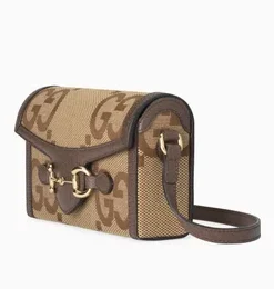 Side view of Gucci Horsebit 1955 Mini Bag in Jumbo GG canvas with leather trim, featuring signature Horsebit hardware and adjustable strap