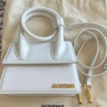 White Jacquemus Le Chiquito Mini handbag showing front design and gold logo.
