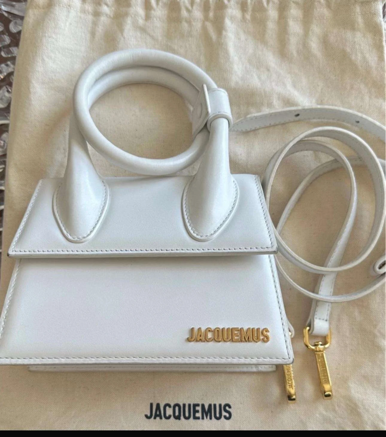 Jacquemus Le Chiquito Mini White Bag Front View White Jacquemus Le Chiquito Mini handbag showing front design and gold logo.