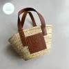 Full view of the artisan-made basket bag, showcasing the intricate woven raffia body and the smooth leather top handles.