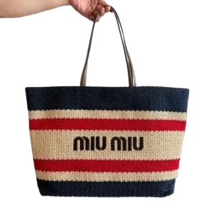 Close-up of Miu Miu woven tote bag with decorative stripes and structured shape.