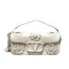 Valentino Garavani VLogo Signature top handle bag crafted from structured exotic embossed leather with detachable shoulder strap.