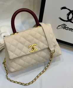 Side view of Chanel Coco Handle Medium handbag in white cream Caviar leather