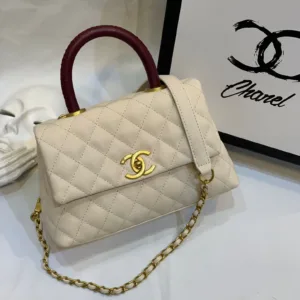Side view of Chanel Coco Handle Medium handbag in white cream Caviar leather