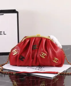 Red pleated leather handbag with gold chain strap and decorative metallic accents