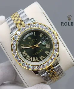 Close-up of a yellow gold Rolex Day-Date 40 with a fluted bezel, featuring a green dial with diamond-set Roman numeral hour markers.