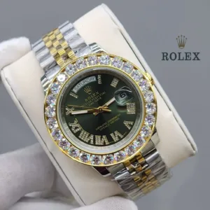 Close-up of a yellow gold Rolex Day-Date 40 with a fluted bezel, featuring a green dial with diamond-set Roman numeral hour markers.