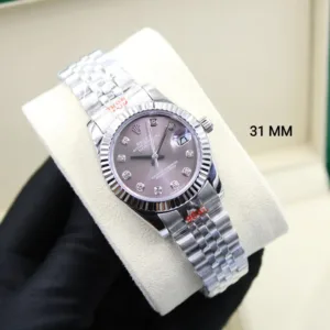 Close-up shot of a 31mm ladies' Rolex Datejust watch on a cream cushion, featuring a stainless steel fluted bezel, Jubilee bracelet, and a purple/brown mother-of-pearl dial with ten diamond markers