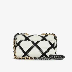 Close-up of black crochet stitching on Chanel 19 small white calfskin bag