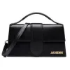 Top-handle black leather Jacquemus bag highlighting its structured shape.