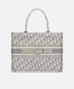 Close-up of authentic Dior Book Tote in gray/beige Oblique motif with 'Christian Dior Paris' band.