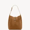 Tan suede hobo shoulder bag featuring the iconic large antique gold-toned YSL Cassandre logo on the front.