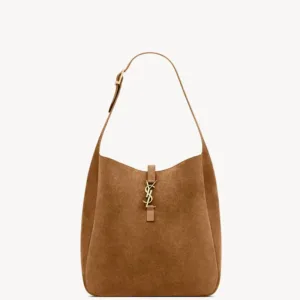 Tan suede hobo shoulder bag featuring the iconic large antique gold-toned YSL Cassandre logo on the front.