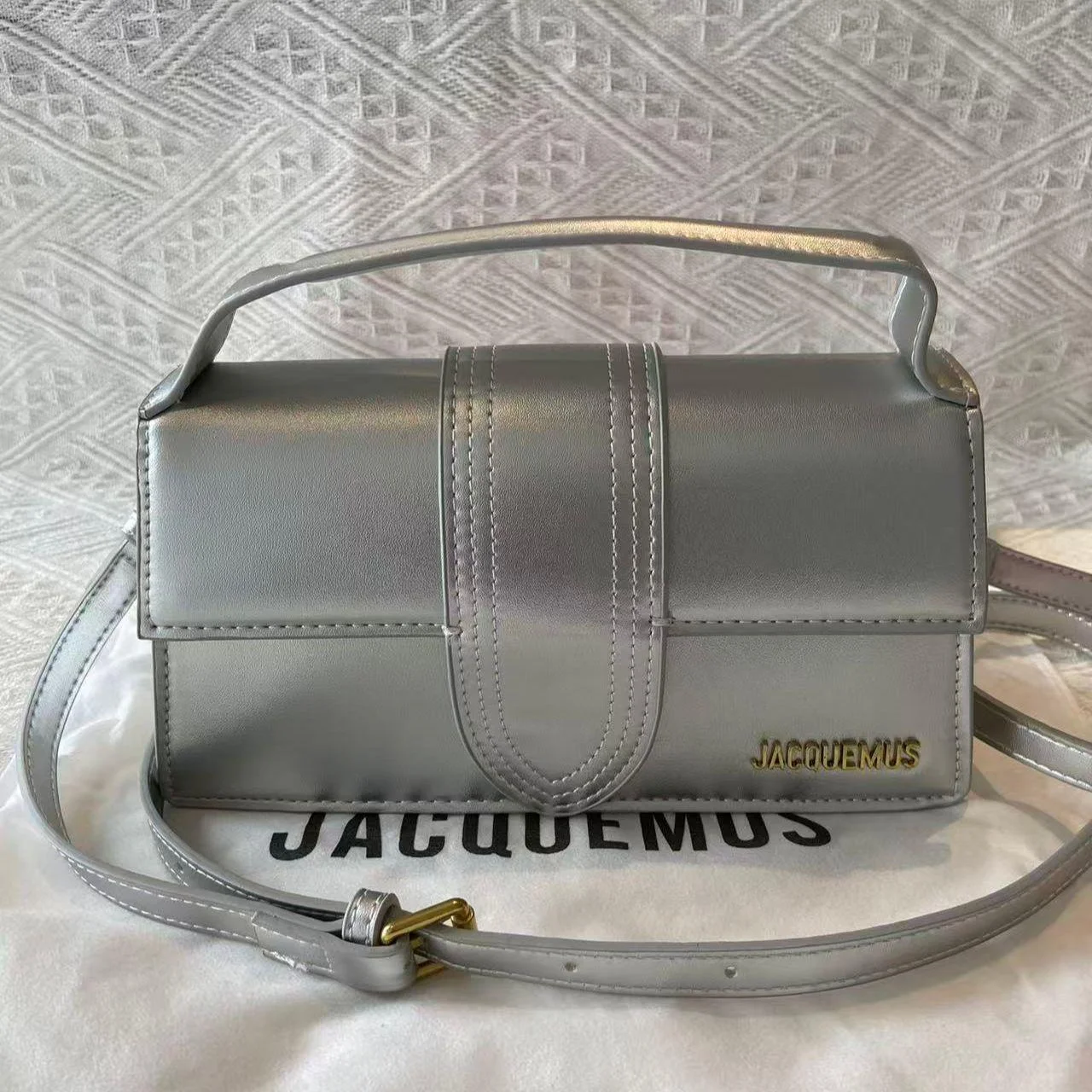 Top-handle leather Jacquemus bag highlighting its structured shape.