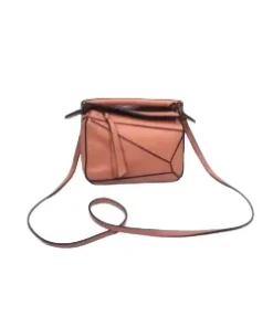 Small Loewe Puzzle bag shown with shoulder strap and top-handle design.