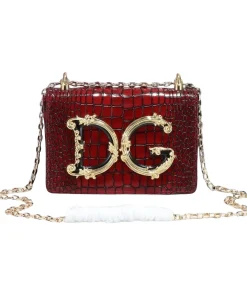 Detailed shot of the rich, textured croc-embossed material and the gold hardware.