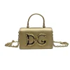 Front view of the gold Devotion mini bag with the large, ornate gold DG logo and top handle.