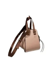 Tan leather Loewe Mini Puzzle Bag viewed from the side, emphasizing the precise cut geometric panels and cuboid shape.