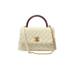 Side view of Chanel Coco Handle Medium handbag in white cream Caviar leather