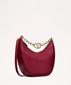Medium-sized red grainy calfskin VLogo Moon hobo bag featuring a large gold chain shoulder strap with VLogo hardware.