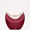 Red grainy leather Valentino Garavani structured top handle bag with pink jewel VLogo Signature and gold chain strap.