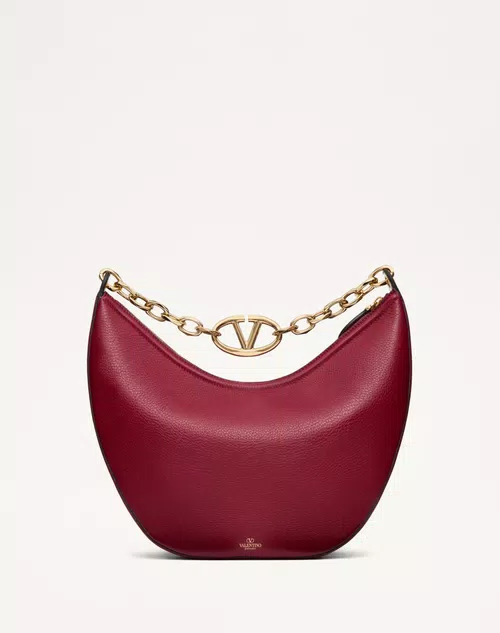 Vlogo-Moon-Medium-Grainy-Calfskin-Hobo-Bag-With-Chain Red grainy leather Valentino Garavani structured top handle bag with pink jewel VLogo Signature and gold chain strap.