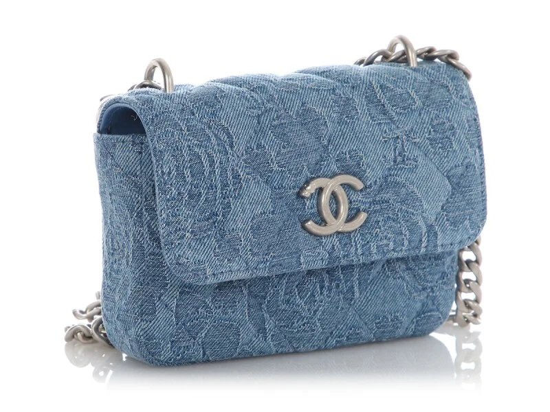 Small Blue Denim Chanel Crossbody Bag Compact light blue denim Chanel bag with a quilted or embossed pattern.