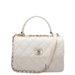 Small quilted Chanel bag in white leather with gold hardware and top handle.