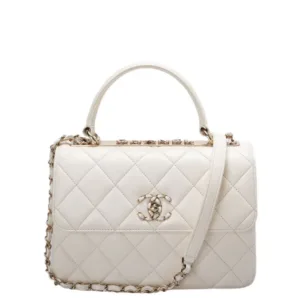Small quilted Chanel bag in white leather with gold hardware and top handle.