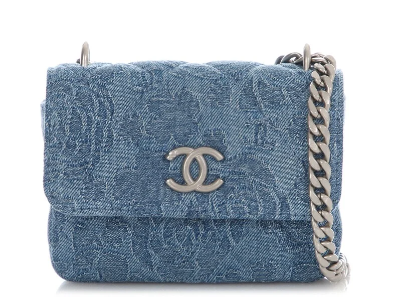 Chanel Blue Denim Flap Bag Floral Embossed Chanel small flap bag in blue denim with subtle floral embossing and silver chain strap.