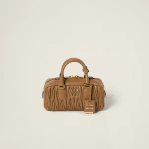 Front view of structured matelassé nappa leather top-handle bag with detailed texture and designer logo