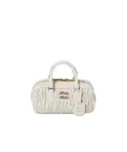 Side angle of elegant nappa leather top-handle bag showing refined silhouette and artisanal finish