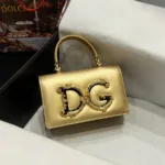Front view of the gold Devotion mini bag with the large, ornate gold DG logo and top handle.