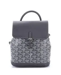 Detailed view of the signature repeating geometric pattern on the stylish mini travel backpack.