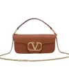 Front view of a luxurious smooth leather Valentino Garavani shoulder bag with a prominent gold VLogo signature and a fine gold chain strap.