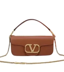 Front view of a luxurious smooth leather Valentino Garavani shoulder bag with a prominent gold VLogo signature and a fine gold chain strap.